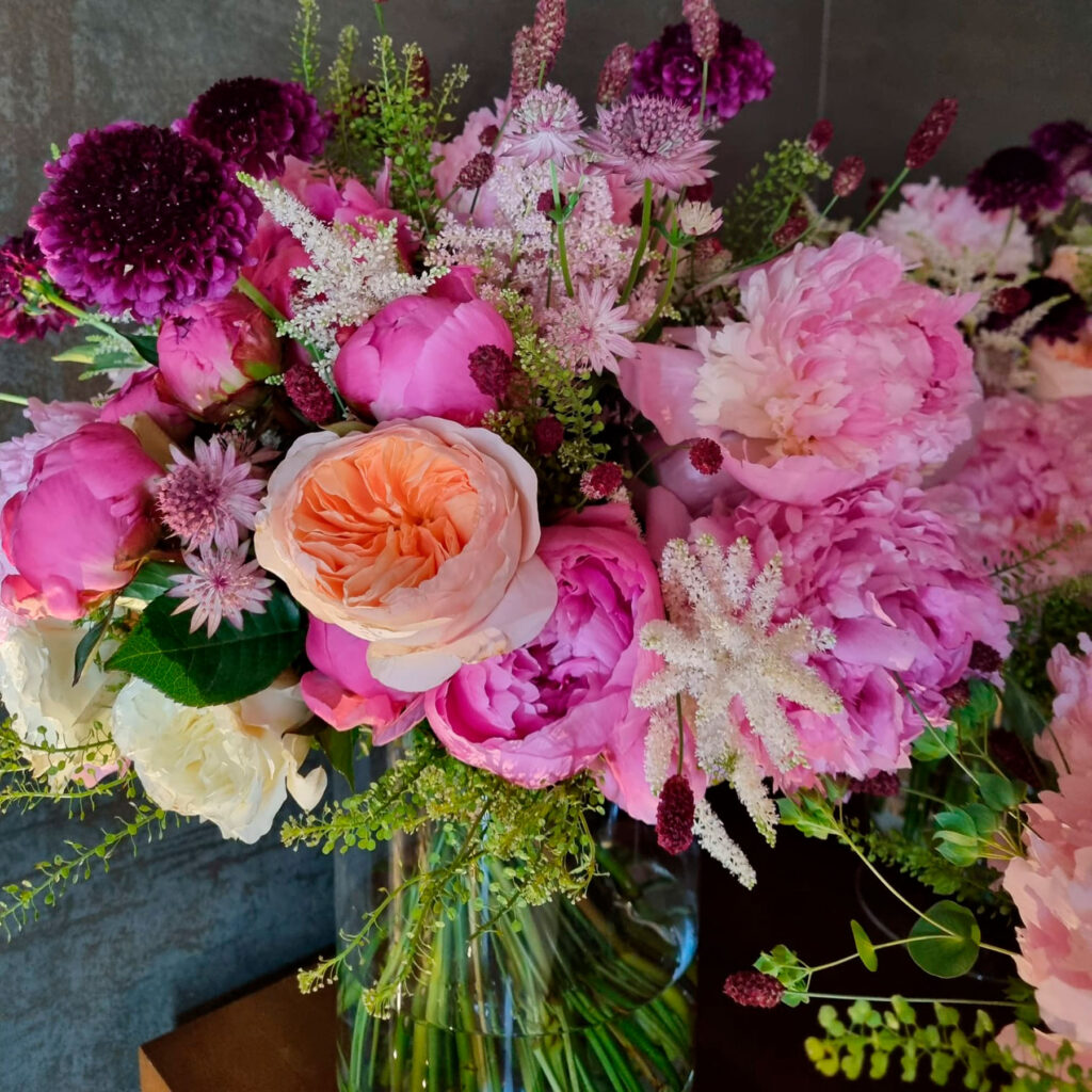 ramo de flores en tonos rosa pastel y blanco e jarrón de cristal